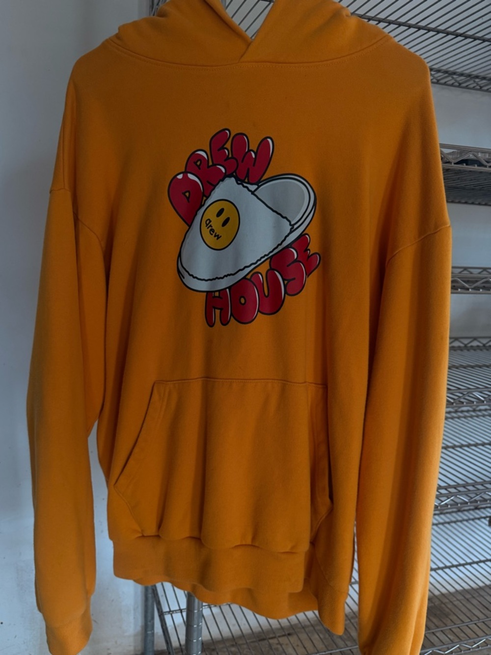 drew house orange pullover hoodie with red graphic